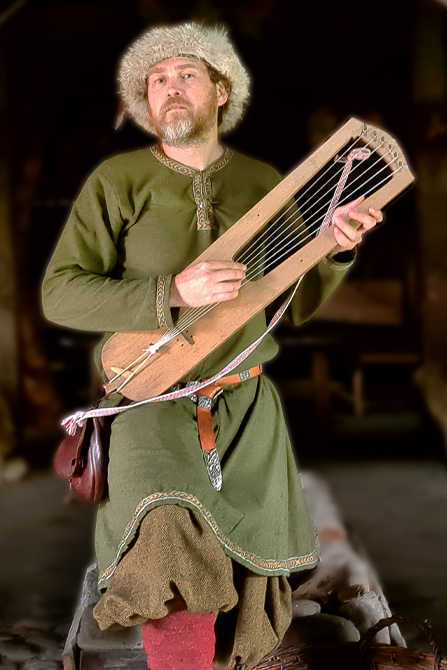 Musician with lyre in a long house